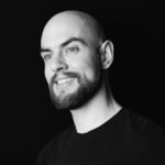 Eric Hinzpeter, a man with a beard smiling